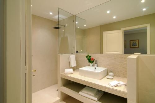 a bathroom with a sink and a mirror at Beachfront Villa in Porto Heli