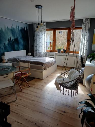 a bedroom with a swing and a bed in it at Eifelsteigzimmer Bruderherz in Gerolstein