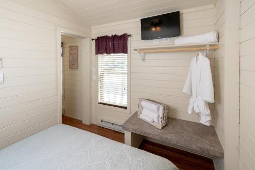 a bedroom with a bed and a tv on the wall at Sun Outdoors Central Coast Wine Country in Paso Robles