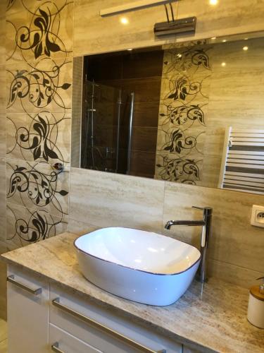 a bathroom with a white sink on a counter at AsPa in Ostrowo