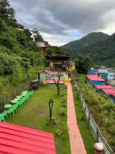 a building on top of a hill with a park at Kaafirana Camps in Dhanaulti
