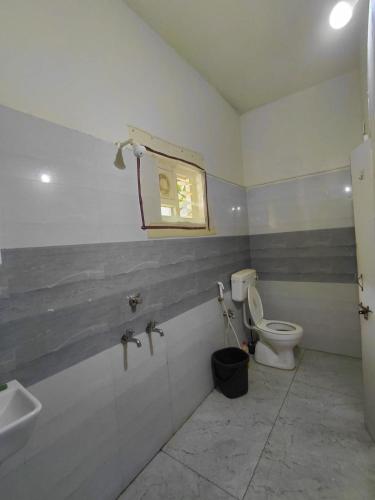 a bathroom with a toilet and a sink at Elite stay villa in Vākalapūdi