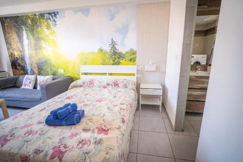 a bedroom with a bed with a blue bag on it at Edificio Prieto VIV 7 in Puerto del Rosario