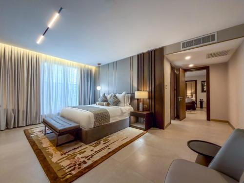 a bedroom with a bed and a large window at The Lusso Hotel in Abuja