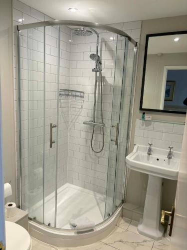 a bathroom with a shower and a sink at The Berkeley Arms Hotel in Berkeley