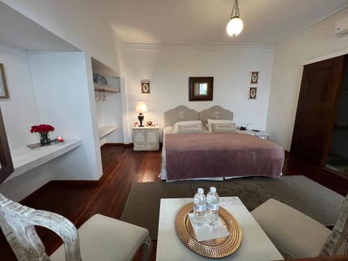 a bedroom with a bed and a table and chairs at Leclerc Hotel Boutique Cali Granada in Cali