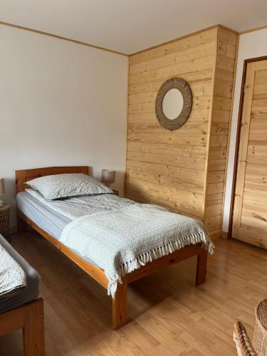 a bedroom with a bed and a mirror on the wall at Nad Stawami - studio in Białowieża