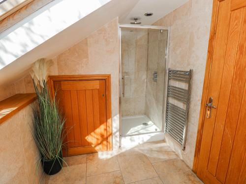 a bathroom with a walk in shower and a glass shower stall at Oak Tree Cottage - Gower in Swansea