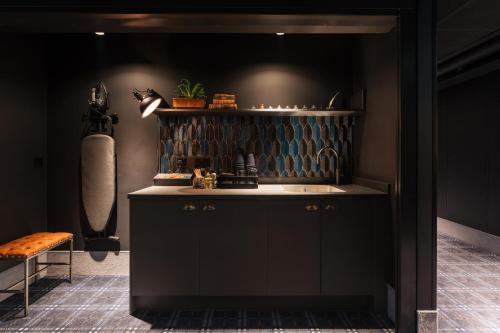 a kitchen with a sink and a counter top at Ruby Stella Hotel London by IHG in London