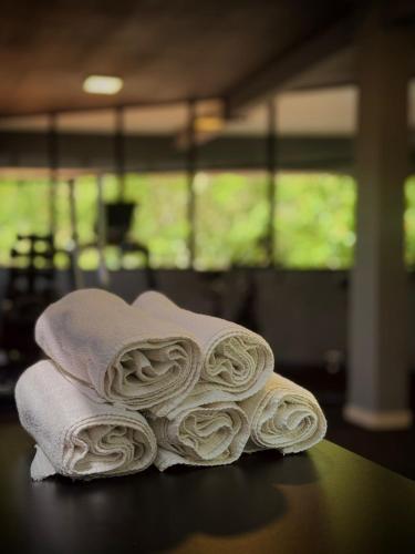 a pile of towels sitting on top of a table at Hotel do Vale in Campina Grande