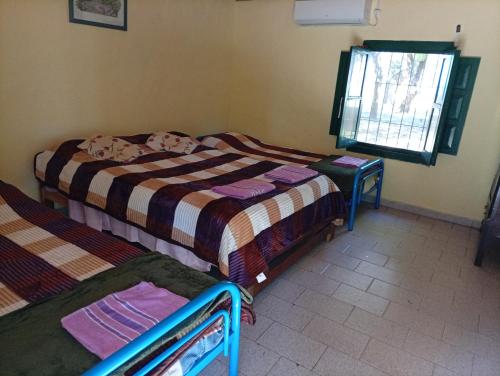 a room with two beds and a window at Finca Re Mar 1 in Santa Ana
