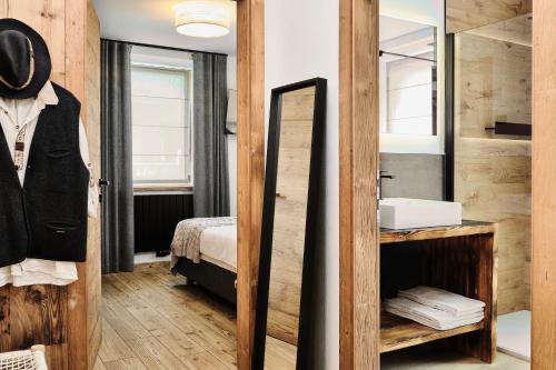a bathroom with a sink and a mirror at Alp Tirol Home in Pellizzano