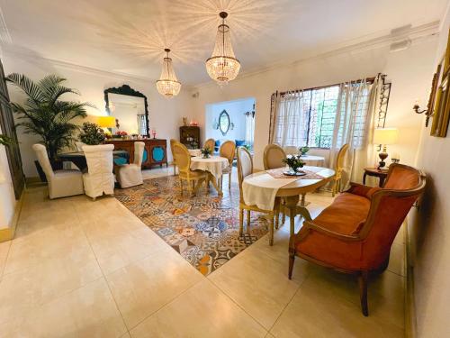 a living room with a table and chairs and a dining room at Leclerc Hotel Boutique Cali Granada in Cali