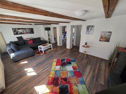 a living room with a couch and a rug at Fewo's kleine Auszeit in Quedlinburg