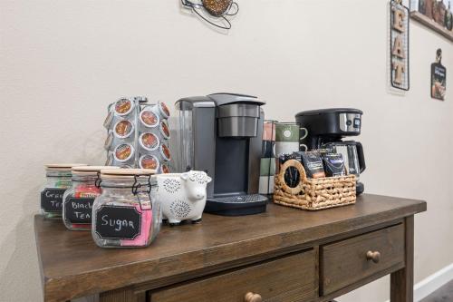 a wooden table with a coffee maker and a coffeeurrection at Spring Special Hot Tub King Beds No Steps No Dog Fee in Branson