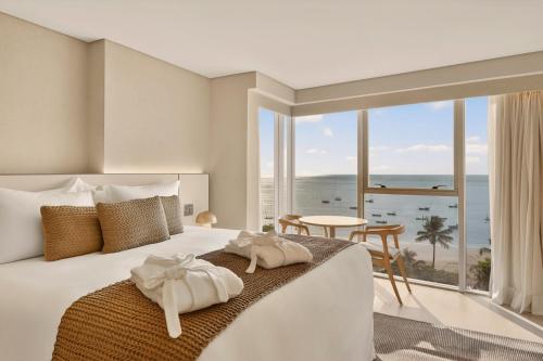 a bedroom with a bed with a view of the ocean at Venti Hotel - By Brisa Hotéis - Soft Opening in Maceió