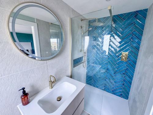 a bathroom with a sink and a mirror at Pengarnedd in Amlwch