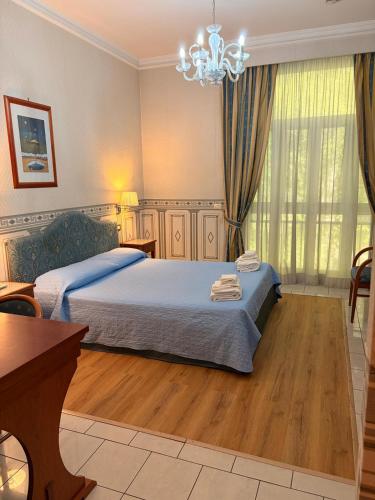 a bedroom with a bed and a chandelier at City Hall in Catania