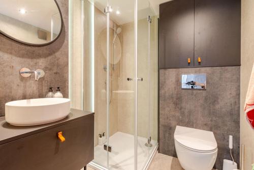 a bathroom with a sink and a toilet and a shower at 53 North in Bodham