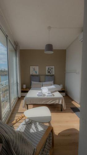 a living room with two beds and a balcony at Sea Balcony House in Senglea