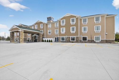 a large building with a parking lot in front of it at Cobblestone Hotel & Suites - Eaton in Eaton