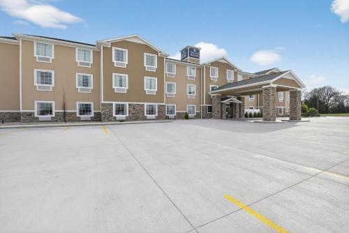 a large building with a parking lot in front of it at Cobblestone Hotel & Suites - Eaton in Eaton