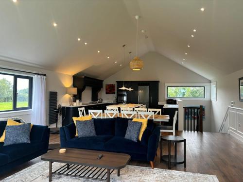 a living room with a blue couch and a table at Lough View Lodge in Ballyronan