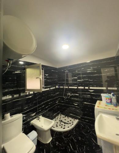 a bathroom with a toilet and a sink at Shtepi Pushimi in Mezhgoran