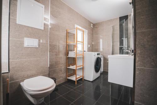 a bathroom with a toilet and a sink at Urban Centre in Bergen