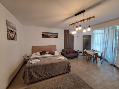 a bedroom with a bed and a dining room at Opium STUDIO ALEZZI in Mamaia Sat/Năvodari