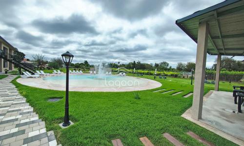 a park with a fountain and a light pole at Lagoon Miramar in Miramar