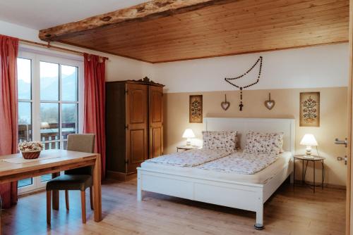 a bedroom with a bed and a table and a desk at Auerhiasbauer in St. Wolfgang
