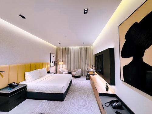 a hotel room with a bed and a television at Copthorne Hotel Sharjah in Sharjah
