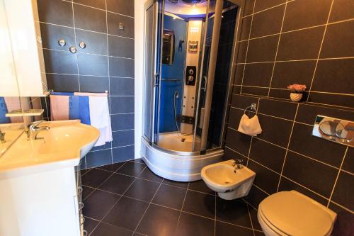a bathroom with a shower and a toilet and a sink at Villa Narcissus Montenegro KO Sveti Stefan in Sveti Stefan