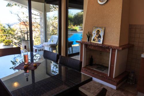 a living room with a fireplace and a view of a pool at Villa Narcissus Montenegro KO Sveti Stefan in Sveti Stefan