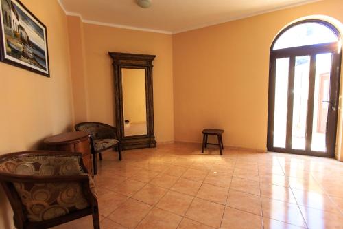 a room with a mirror and chairs and a window at Villa Narcissus Montenegro KO Sveti Stefan in Sveti Stefan