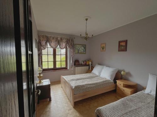 a bedroom with two beds and a window at Siedlisko Studzianki in Studzianki Pancerne