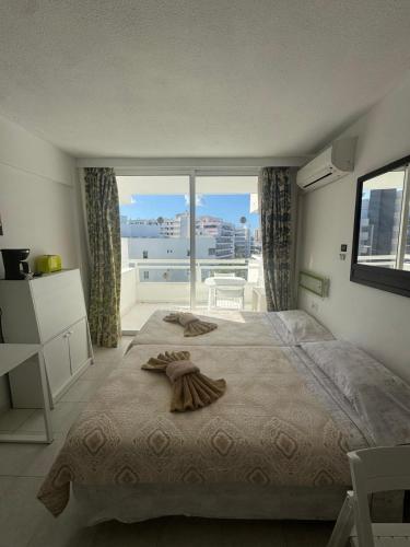 a bedroom with a large bed and a large window at Casa climatizada in Playa Fañabe
