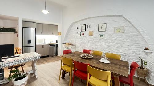 a kitchen and dining room with a table and chairs at Pefkakia Park in Ermoupoli
