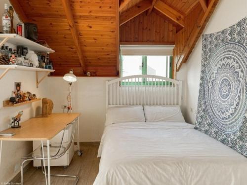 a bedroom with a white bed and a desk at Home for Air -- 9 minutes from sea of Galilee in Giv'at Yo'av