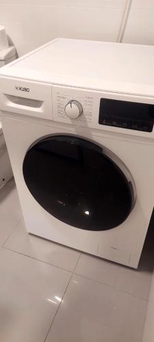 a white microwave oven sitting on top of a counter at Santiago Apartment in Caminha