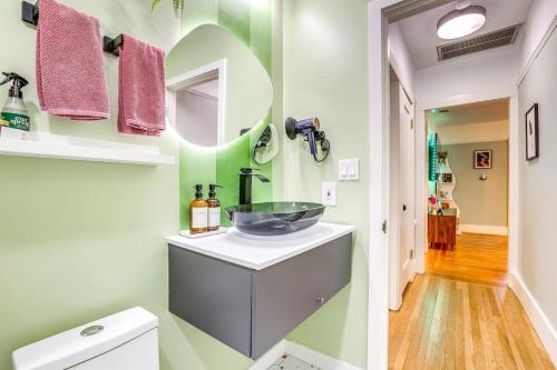 a bathroom with a sink and a mirror at Midtown Oasis - BBQ, Deck, Games & Artistic Vibes in Sacramento