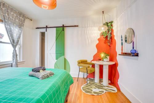 a bedroom with a bed and a table and a chair at Midtown Oasis - BBQ, Deck, Games & Artistic Vibes in Sacramento