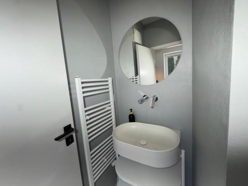 a bathroom with a white toilet and a mirror at Apartmán Zamarovce in Trenčín