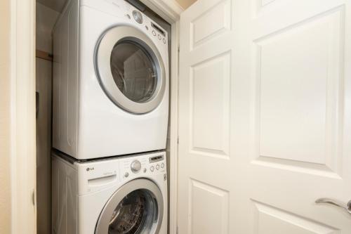 a laundry room with a washer and dryer next to a door at 175 Spinner 5-2 in Fraser