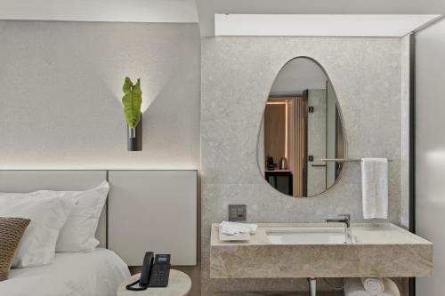 a hotel room with a sink and a mirror at Venti Hotel - By Brisa Hotéis - Soft Opening in Maceió