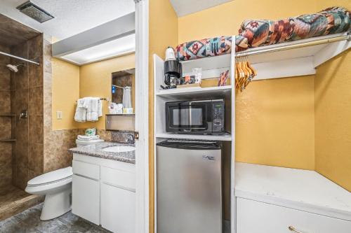 a small bathroom with a toilet and a microwave at Travelodge by Wyndham Kanab in Kanab