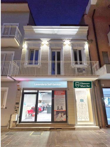 a store front of a building with a balcony at Dimore Marche Porto Recanati in Porto Recanati