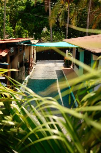 a building with a swimming pool in front of it at Panama Beach Lodge in San Carlos