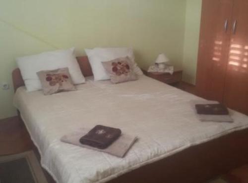 a bed with two towels on top of it at Apartmani Borić in Orebić